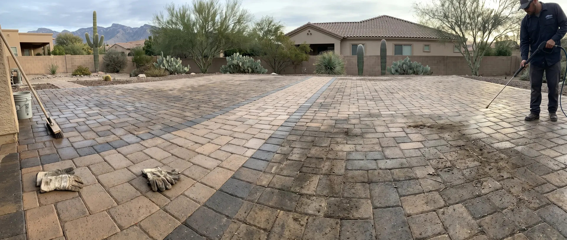 Weathered paver patio being cleaned in sections
